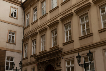 A large and impressive building that features numerous windows and has a distinct red door that stands out beautifully
