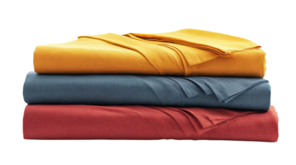 Cozy blankets in warm hues stacked neatly on a soft surface for a relaxing afternoon