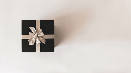 Black gift box from top view. Concept minimalist for wrapped Christmas and other holiday gifts....