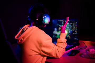 Photo of cute lovely nice girl back view amazed raise hand play gamer computer laptop modern technology indoors late night © deagreez