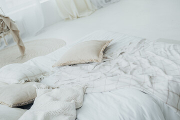 Cozy white bedroom setting with soft bedding and decorative pillows