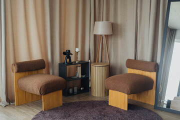 Cozy modern interior with stylish chairs and decorative lamp elements