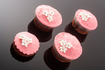 Tasty colorful cupcakes on blackbackground