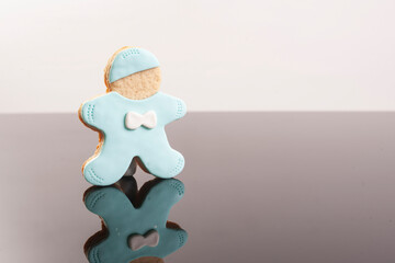 Baby cookies decorated with glaze on a black background. Baby boy.
