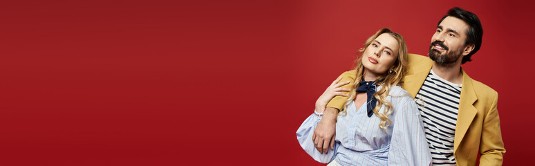 A middle aged couple exudes charm and style while enjoying a lighthearted moment together.