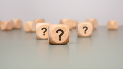 Question Marks on Wooden Blocks Symbolize the Concept of Uncertainty in Various Contexts