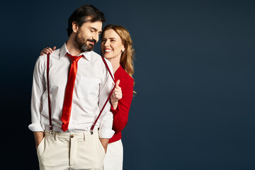 A couple enjoys a lighthearted interaction while dressed fashionably with vibrant colors.