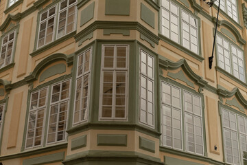 There is a large building characterized by numerous windows adorning its side, providing a modern and appealing urban aesthetic