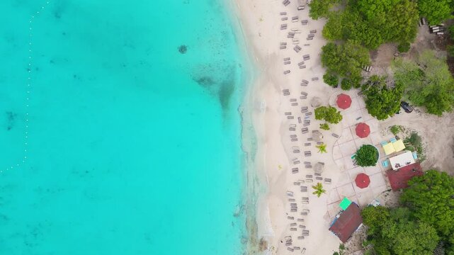 Aerial bird's eye view above turquoise waters at Grote knip or Kenepa Grande , Curacao, scenic beach and vibrant island greenery on a bright, sunny day