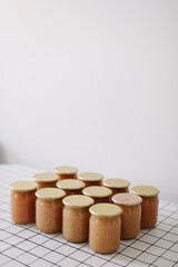 apple jam in jar on a light background in rustic style