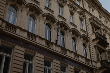 A substantial and expansive building that features numerous windows and several balconies, adding to its character and charm