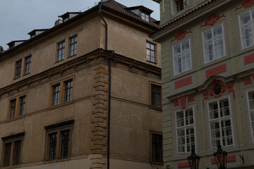 There is a large building that features numerous windows located right next to another building, making the area visually interesting