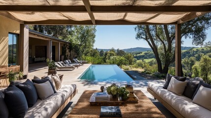 Fototapeta premium Spacious outdoor lounge under a contemporary pergola, with soft cushions and a pool view.