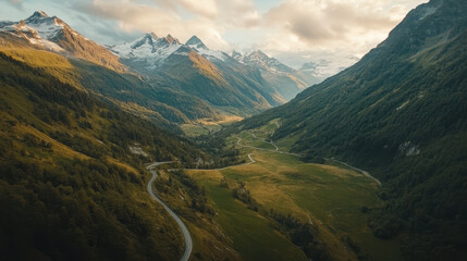 A mountain range with a winding road that leads to the top