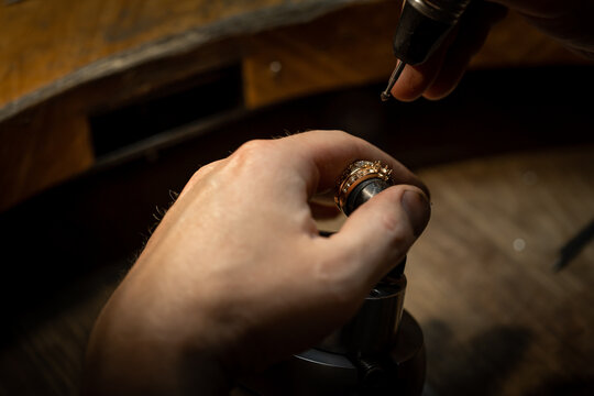 craftsman making diamond ring. hand made jewelry. Put diamond gem ring. diamond ring production craftsman workshop. solitaire ring making
