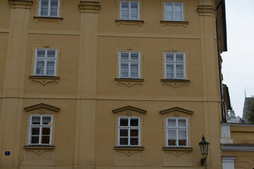 A very large yellow building that features numerous windows and has a unique architectural design, making it quite a sight to behold