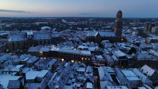 Zwolle downtown district during a cold winter morning seen from above with the rooftops a covered in a thin layer of snow.