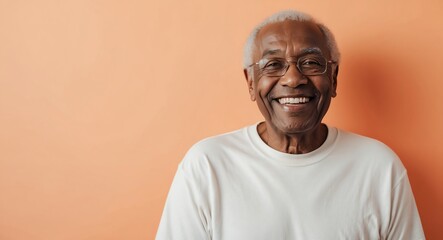 Obraz premium mixed race elderly man orange background wearing plain white tshirt smiling happy portrait