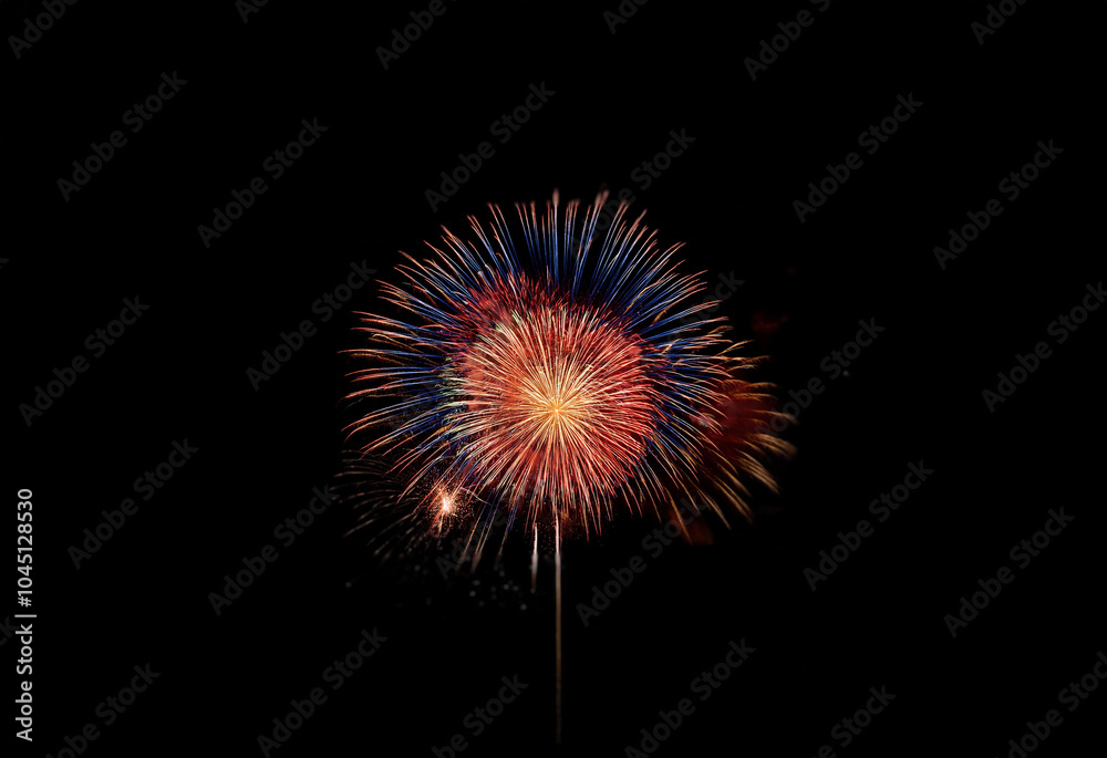 Aufkleber a single firework explodes in a burst of red, blue, and yellow against a black background.