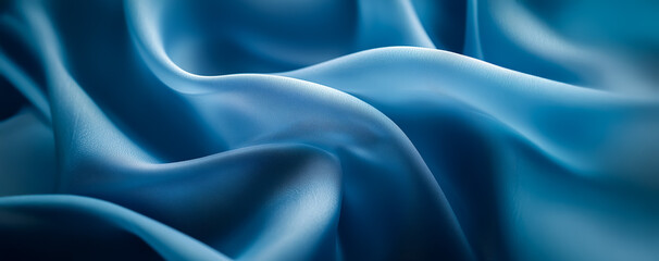 Obraz premium A detailed close-up of blue silk fabric with delicate folds, creating a luxurious and soft appearance, highlighting the high-quality texture of the material.