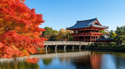 Naklejka premium Scenic view of a traditional Japanese building surrounded by vibrant autumn foliage and a tranquil pond.