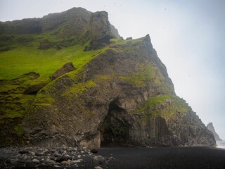 Scenic view of Halsanefshellir Cave on Reynisfjara Black Sand Beach, against the sky in Iceland