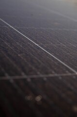 Close-up of dusty solar panel surface with visible dirt accumulation and grid lines, illustrating...
