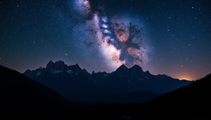 Majestic mountains illuminated by the Milky Way in a starry night sky