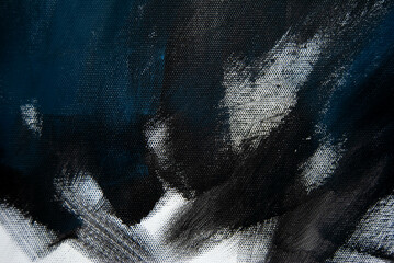 Brush strokes of dark blue and black acrylic paint create a bold and textured pattern on canvas.