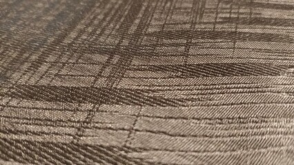 Closeup of a brown fabric with a checkered pattern.