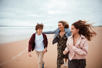 Family walking on the beach during vacation