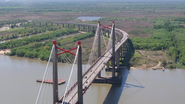 Drone view of Justo Jose de urquiza bridge above the wide Parana Guazu river, a vast waterway, Buenos Aires Argentina. Pan to the left, close view
