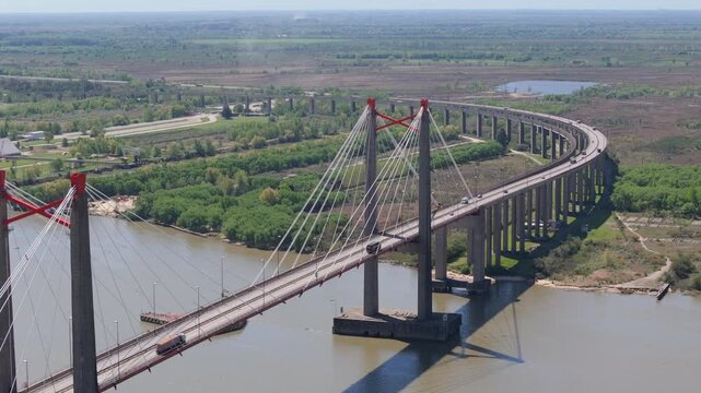Drone view of Justo Jose de urquiza bridge above the wide Parana Guazu river, a vast waterway, Buenos Aires Argentina. Flying to the left