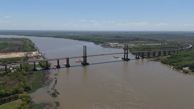 Drone view of Justo Jose de urquiza bridge above the wide Parana Guazu river, a vast waterway, Buenos Aires Argentina. Flying to the right