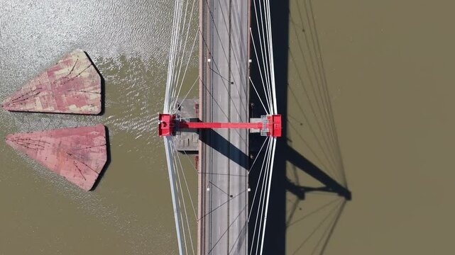 Drone view of Justo Jose de urquiza bridge above the wide Parana Guazu river, a vast waterway, Buenos Aires Argentina. Top down view ascending