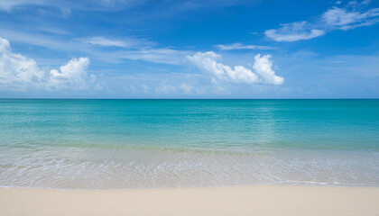 Obraz premium Serene Beach with Turquoise Waters and Soft White Clouds