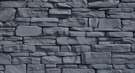 Dark grey painted stone wall background rough grey stones with visible paint and uneven texture