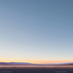 Fototapeta premium American desert highway with clean blue sky with sunset. Road side is visible at the bottom of the image