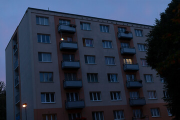 A large modern building featuring numerous windows and elegant balconies that are beautifully...