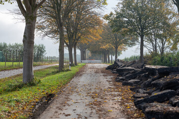 Road construction in Germany. Crushed concrete blocks of the old street on a country road.