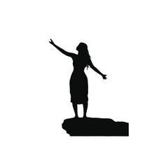 A silhouette of a young woman with long hair standing on a rock formation