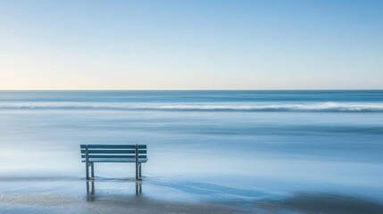 Fototapeta premium Bench by the sea on a tranquil beach, no one in sight, with soft waves and a calm horizon creating a peaceful atmosphere.