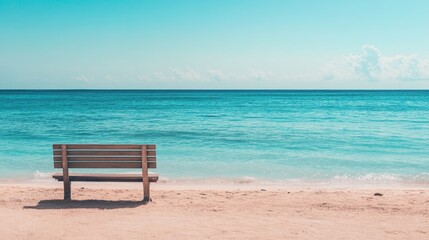 Bench by the sea on a tranquil beach, no one in sight, with soft waves and a calm horizon creating a peaceful atmosphere.