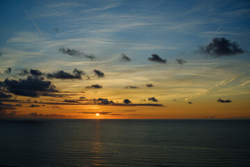 Romantic colorful sunset at the sea. View of Beautiful glorious golden sunset and golden hour above the sea in evening.