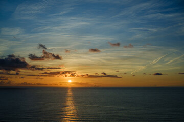 Romantic colorful sunset at the sea. View of Beautiful glorious golden sunset and golden hour above the sea in evening.