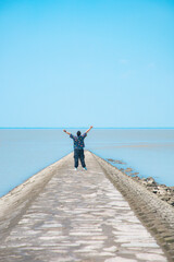 Hengsha Island, Shanghai - young man standing on the beach under the blue sky