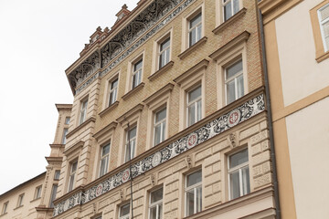 A large and impressive building that features a significant number of windows adorning the side of it, showcasing its architectural design