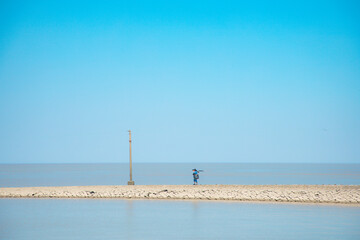 Fototapeta premium Hengsha Island, Shanghai - People standing by the railing under a blue sky