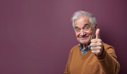 Senior man with cheerful expression giving thumbs up against purple background with copy space