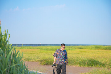 Fototapeta premium Chongming Island, Shanghai - Portrait of a person standing in a reed marsh